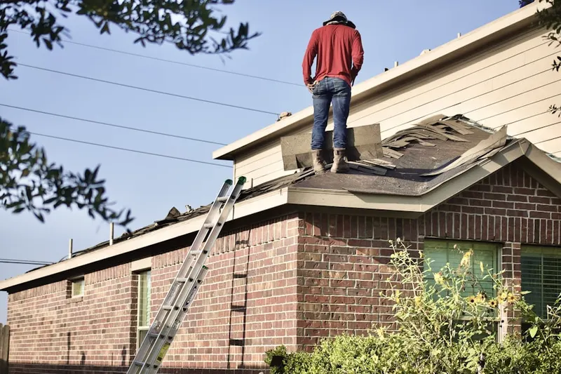Professional roofer working on a residential roof in Matthews